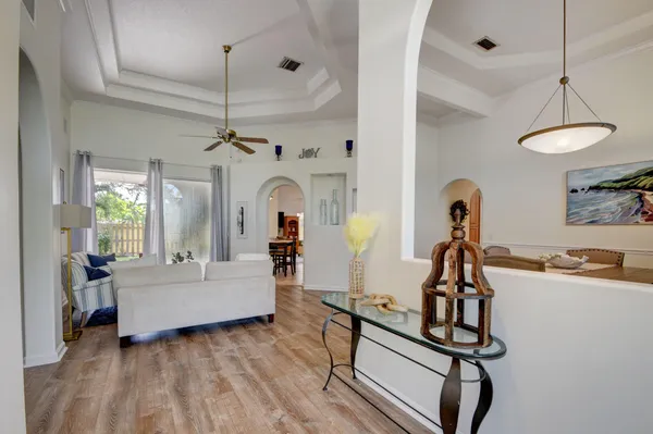 a living room with furniture a dining table and chairs with wooden floor