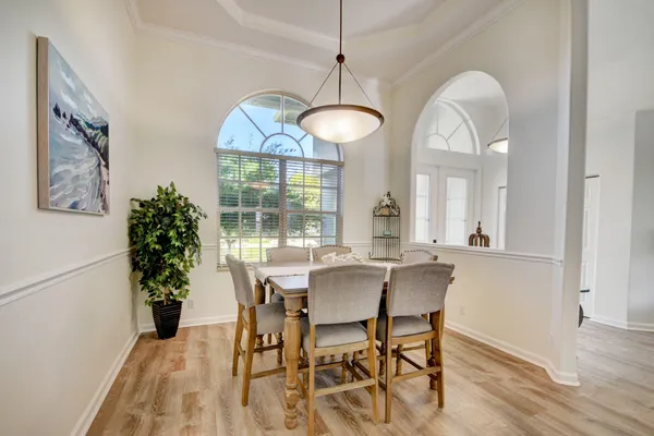 a view of a dining room with furniture and chandelier
