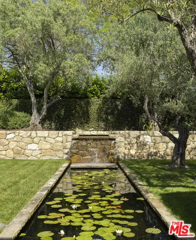 a view of a swimming pool with a yard
