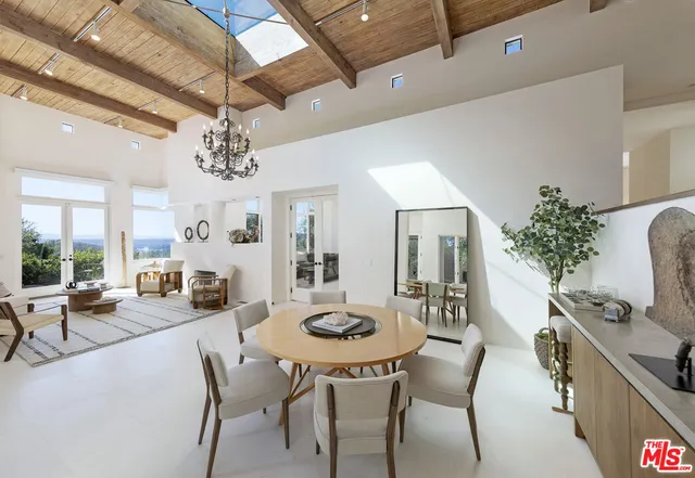 a view of a dining room with furniture and chandelier