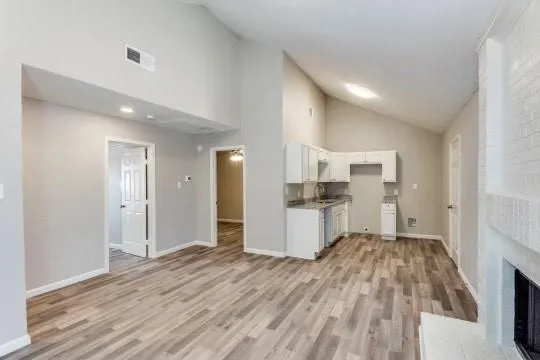 a open kitchen with a sink and dishwasher a refrigerator with wooden floor