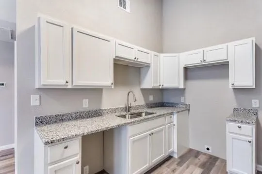 a kitchen with stainless steel appliances granite countertop a sink stove and cabinets