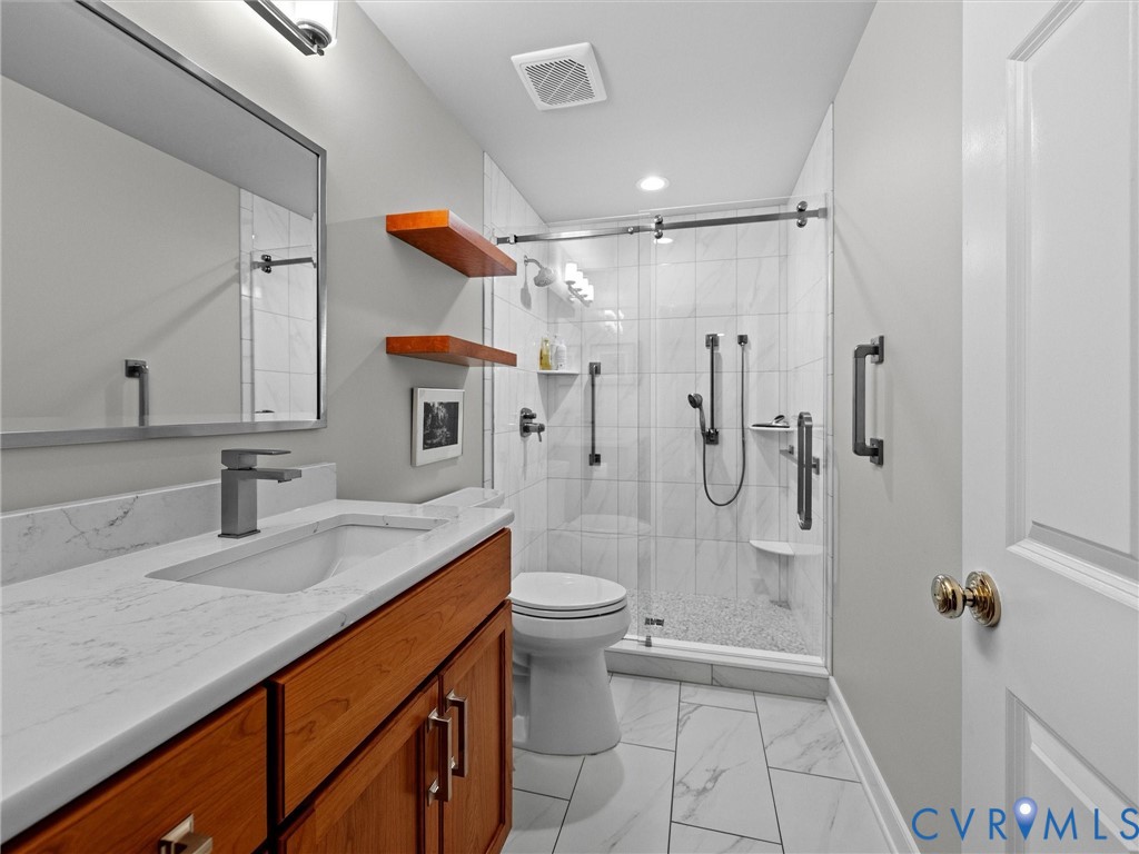 4428 Shirley Road Richmond, VA 23225 - Photo 40 of 70 Full bath has a walk-in shower and grab bars.