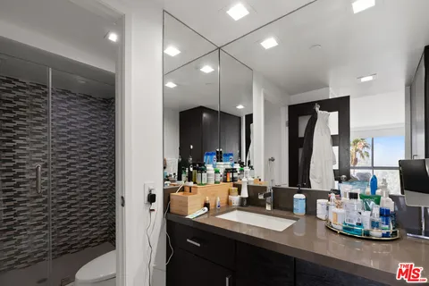 a bathroom with a double vanity sink a toilet and a mirror