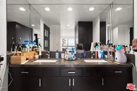 a kitchen with counter top space and living room view