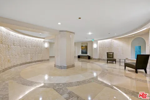 a view of a hallway with seating area