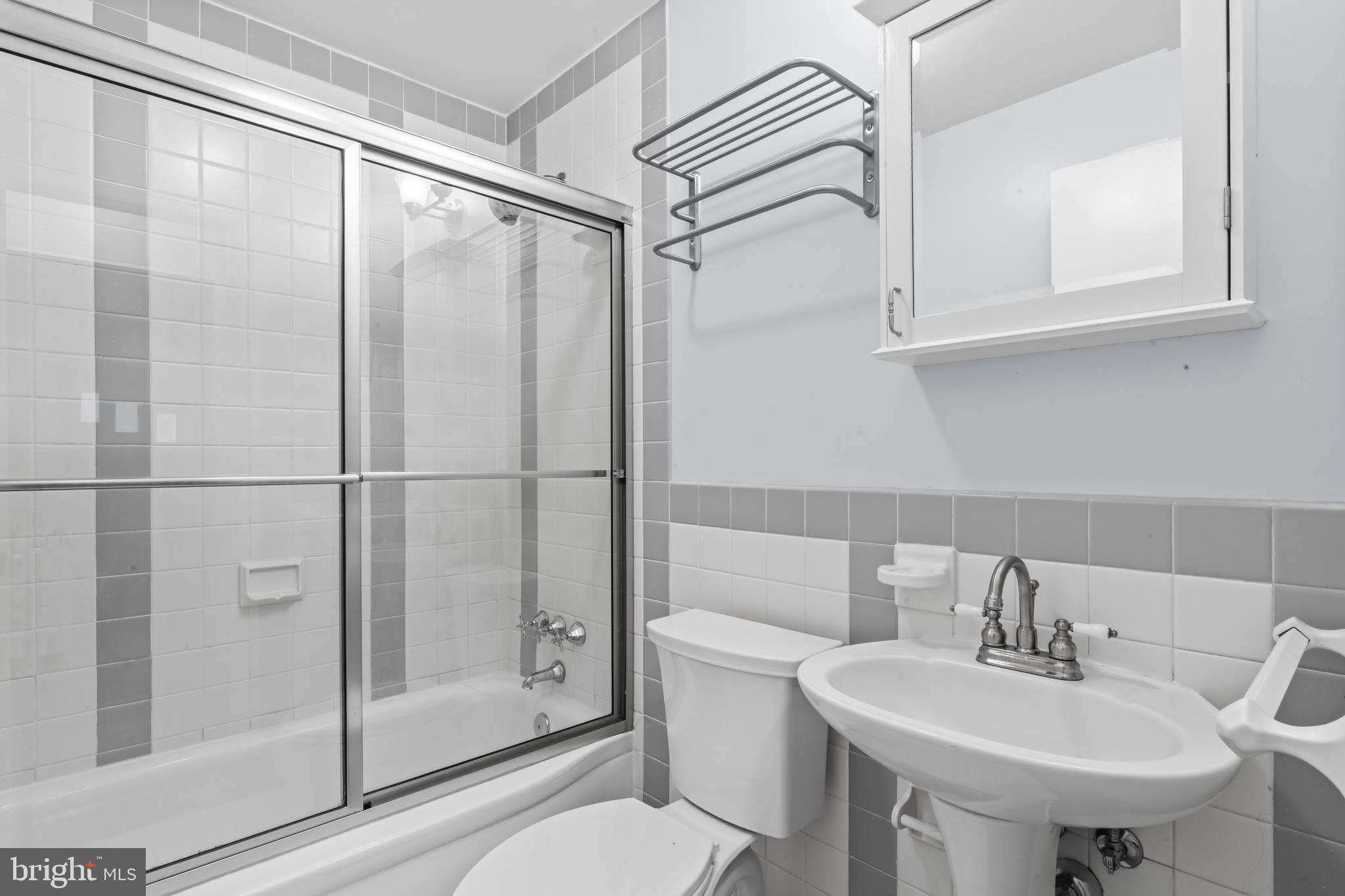 12131 Waples Mill Road Oakton, VA 22124 - Photo 11 of 40 a bathroom with a sink toilet and shower
