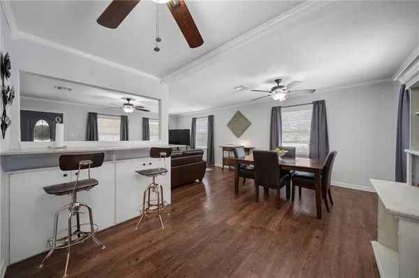 a view of a dining room with furniture and wooden floor
