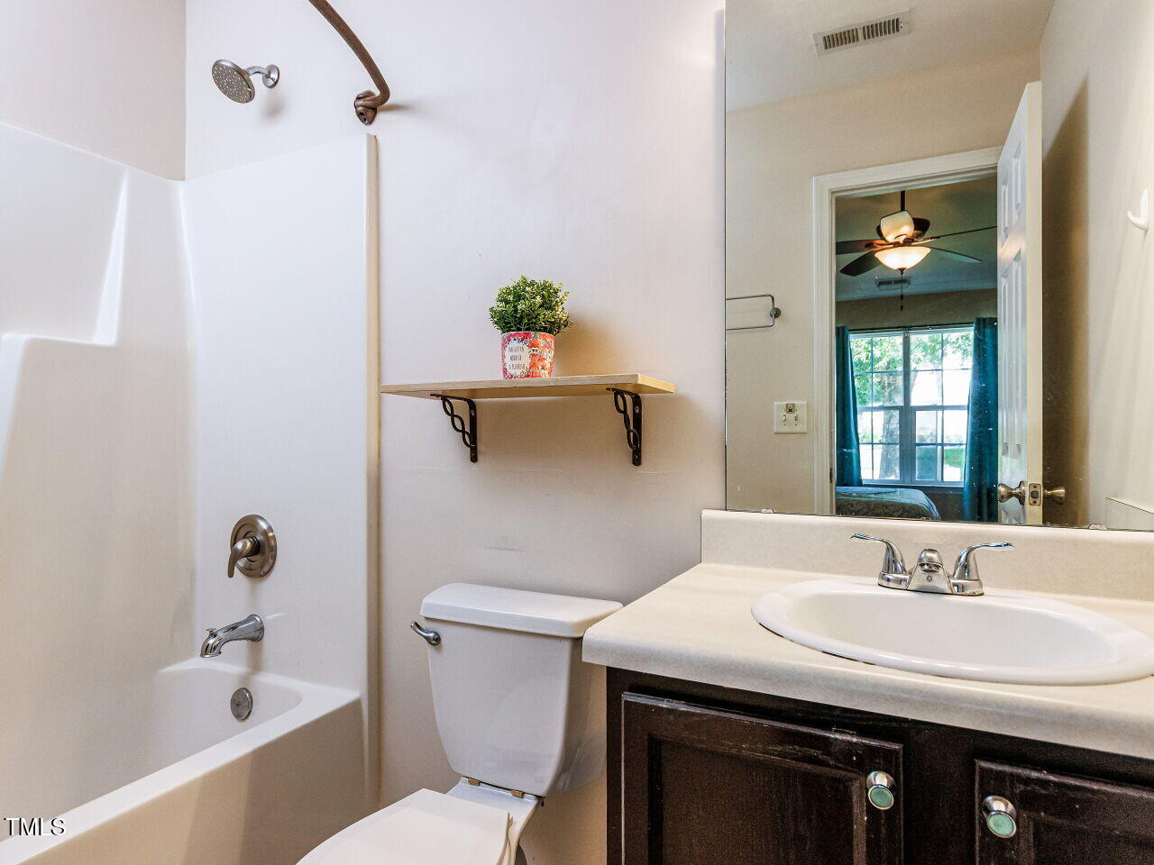 3665 Watkins Ridge Court Raleigh, NC 27616 - Photo 13 of 28 a bathroom with a sink a toilet and shower