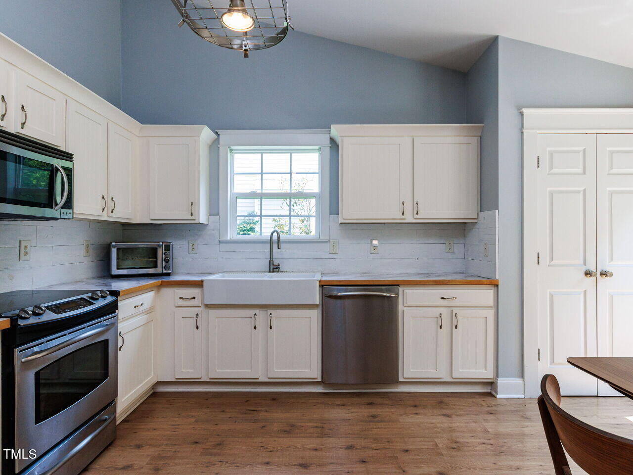 3665 Watkins Ridge Court Raleigh, NC 27616 - Photo 7 of 28 a kitchen with stainless steel appliances granite countertop a stove a sink and a microwave