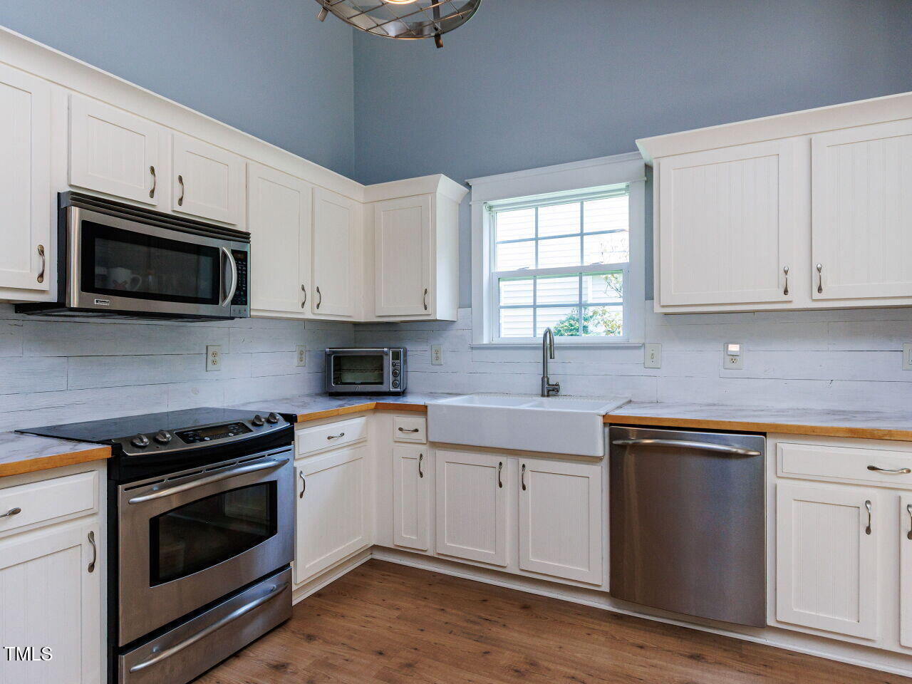 3665 Watkins Ridge Court Raleigh, NC 27616 - Photo 8 of 28 a kitchen with cabinets stainless steel appliances a sink and a window