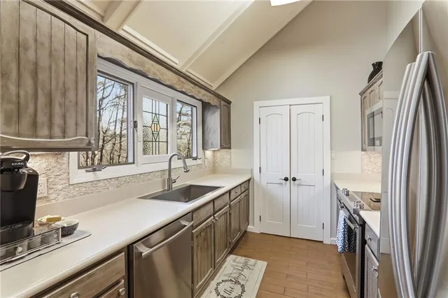 a kitchen with a sink stove and refrigerator