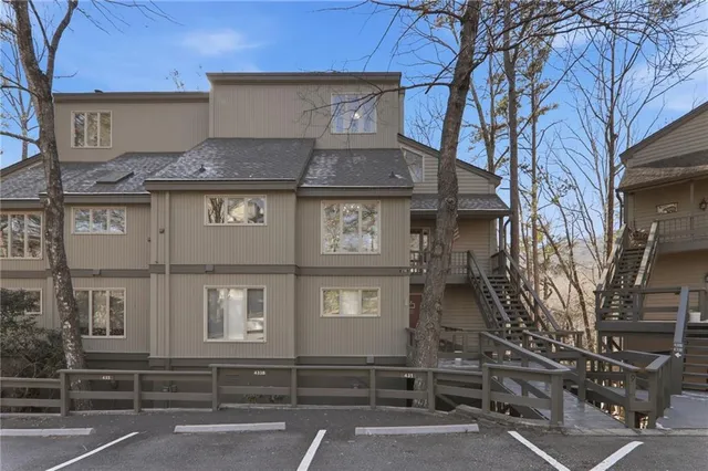 a front view of a residential apartment building with a yard