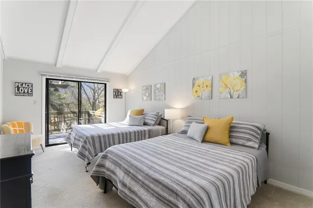 a bedroom with two beds and a large window