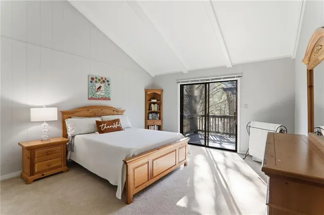 a bedroom with a bed and large window