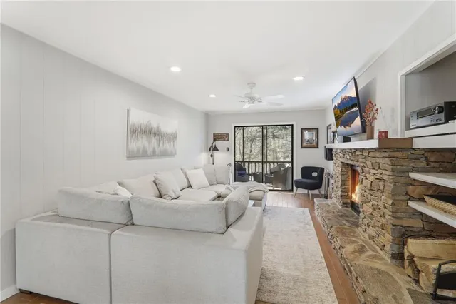 a living room with furniture a fireplace and a flat screen tv