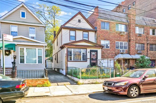 a view of a car park in front of a brick house
