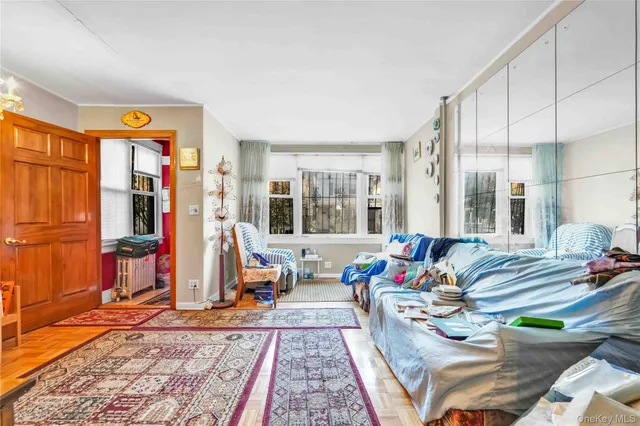 a living room with furniture a rug and white walls