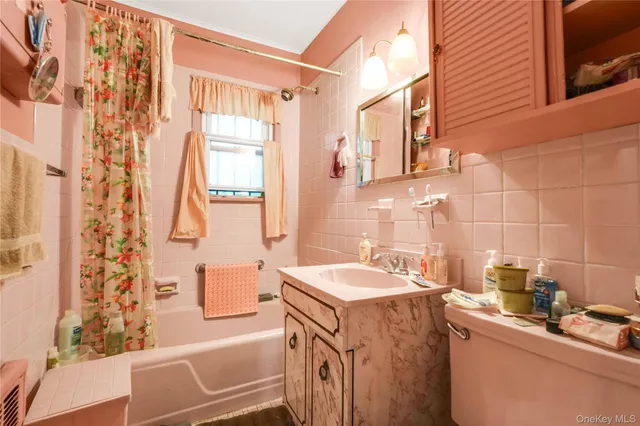 a bathroom with a sink a large mirror and a bathtub