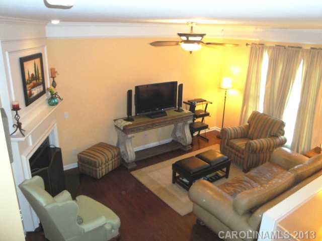 668 6th Baxter Crossing, Unit 111 Fort Mill, SC 29708 - Photo 10 of 16 a living room with furniture and a fireplace