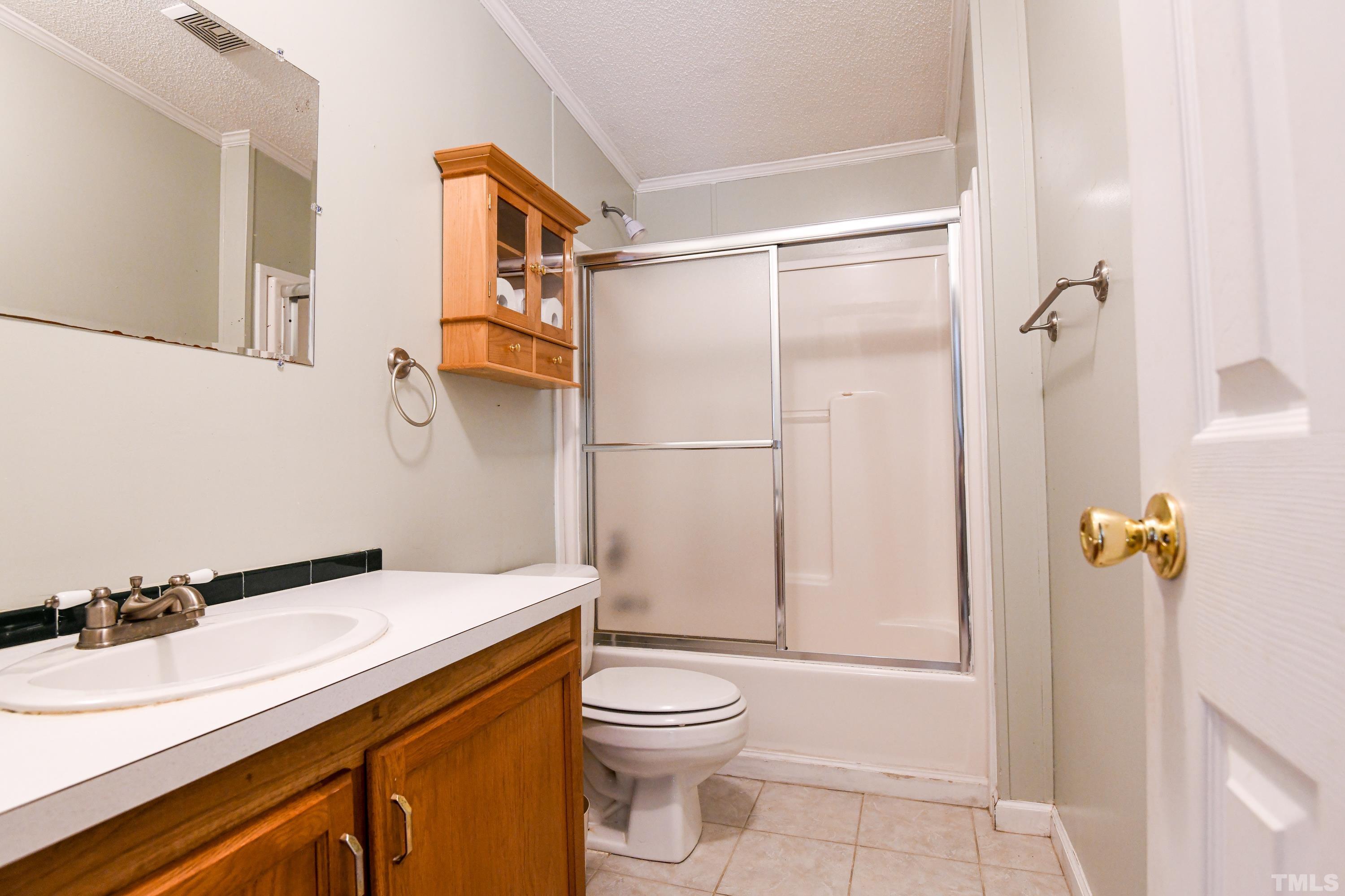 1516 Bill Poole Road Rougemont, NC 27572 - Photo 11 of 17 a bathroom with a sink a toilet and shower