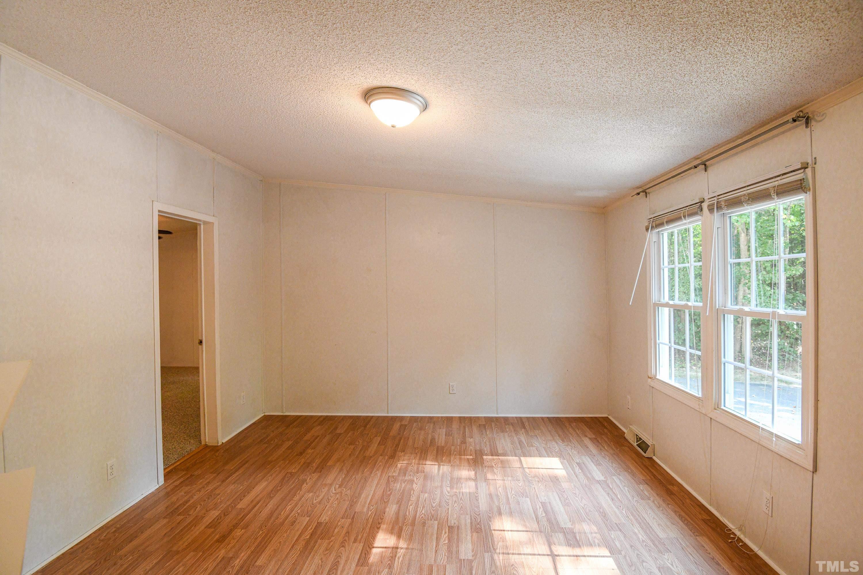 1516 Bill Poole Road Rougemont, NC 27572 - Photo 5 of 17 wooden floor in an empty room with a window