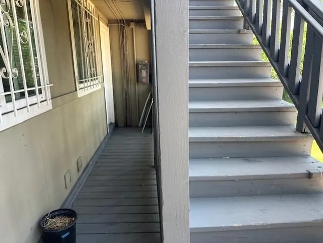 a kitchen with stainless steel appliances granite countertop a refrigerator a sink dishwasher and wooden cabinets with wooden floor