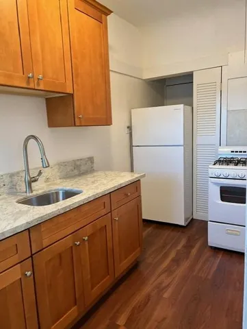 a kitchen with stainless steel appliances granite countertop wooden cabinets a sink and dishwasher