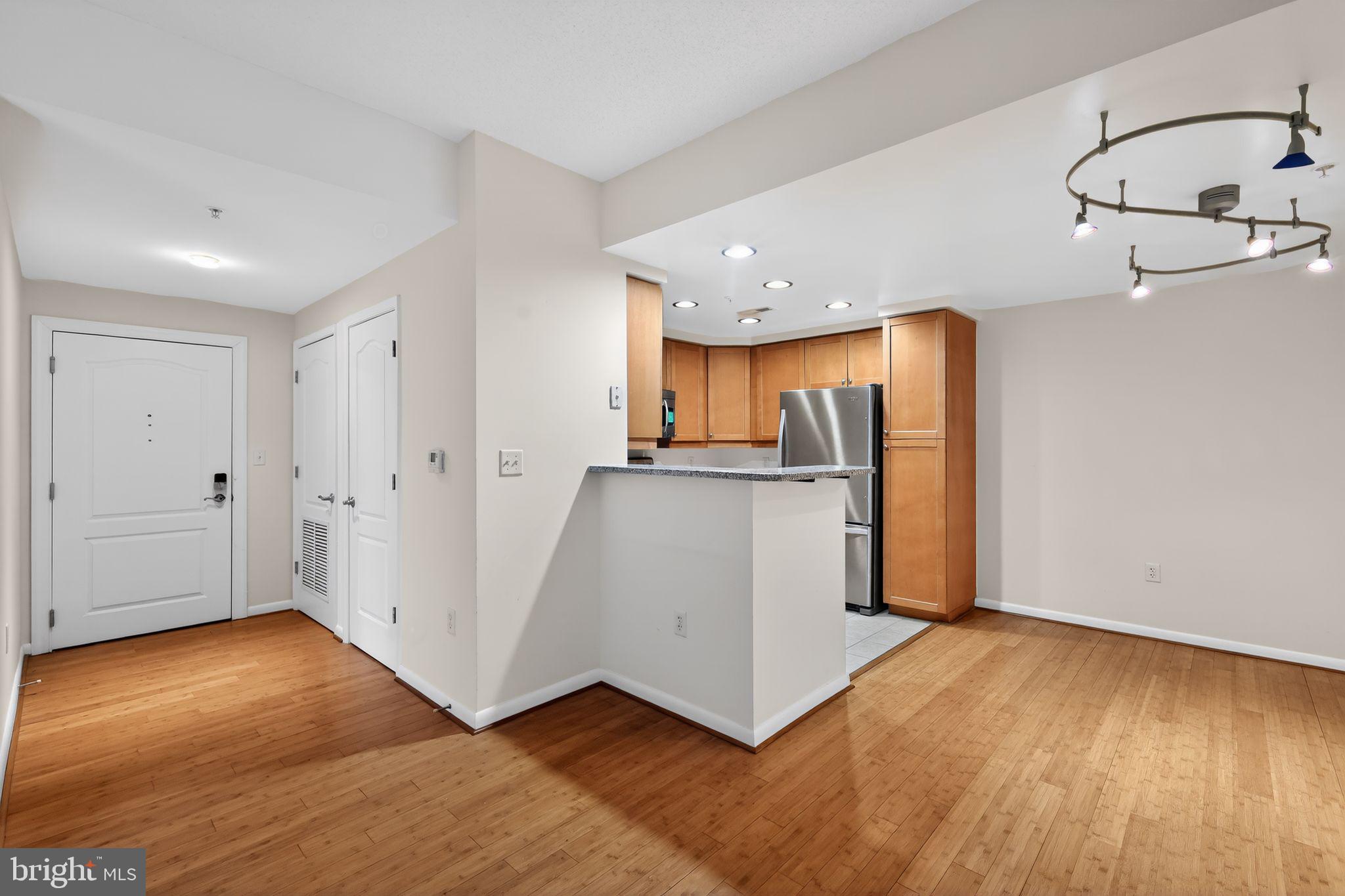 1111 11th Street Northwest, Unit 308 Washington, DC 20001 - Photo 11 of 47 a view of a kitchen with wooden floor and a sink