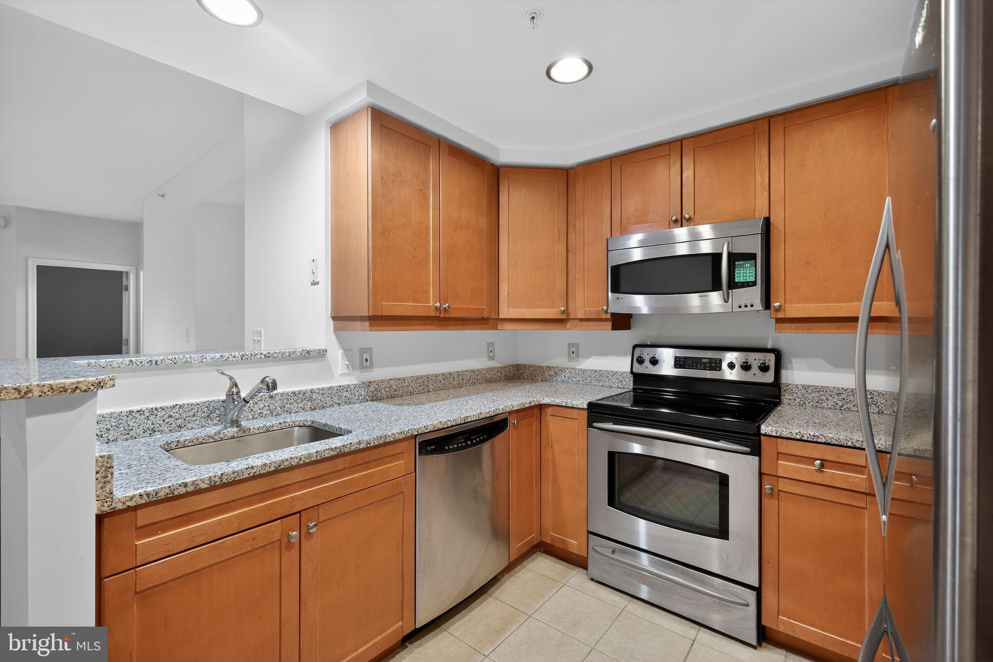 1111 11th Street Northwest, Unit 308 Washington, DC 20001 - Photo 13 of 47 a kitchen with a sink stove and microwave