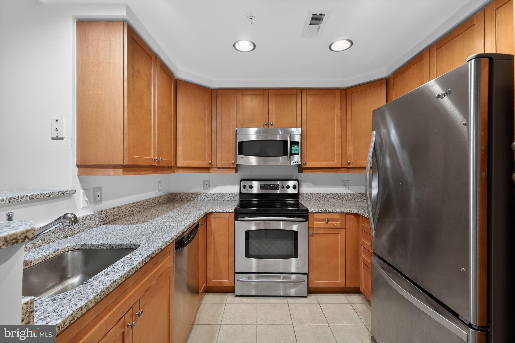 1111 11th Street Northwest, Unit 308 Washington, DC 20001 - Photo 15 of 47 a kitchen with stainless steel appliances granite countertop a sink stove and refrigerator