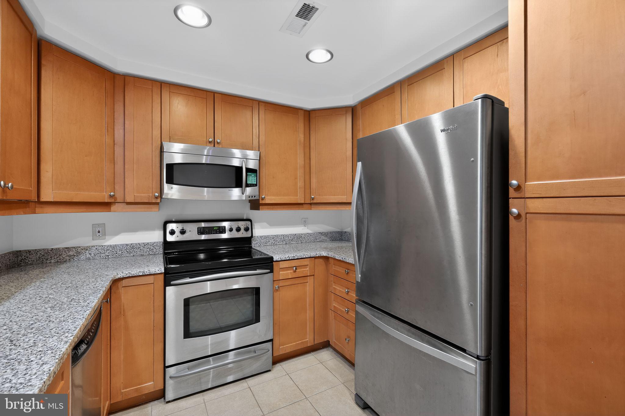 1111 11th Street Northwest, Unit 308 Washington, DC 20001 - Photo 16 of 47 a kitchen with stainless steel appliances granite countertop a refrigerator stove and microwave