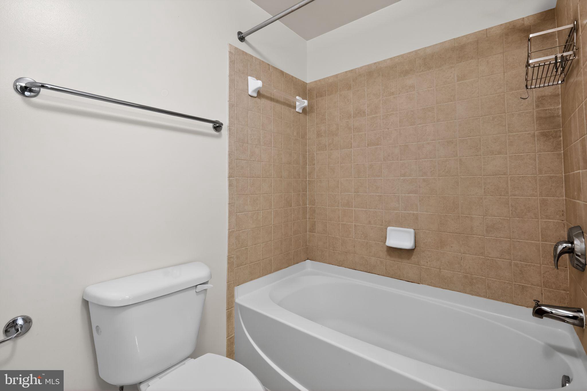 1111 11th Street Northwest, Unit 308 Washington, DC 20001 - Photo 18 of 47 a bathroom with a toilet and a bathtub