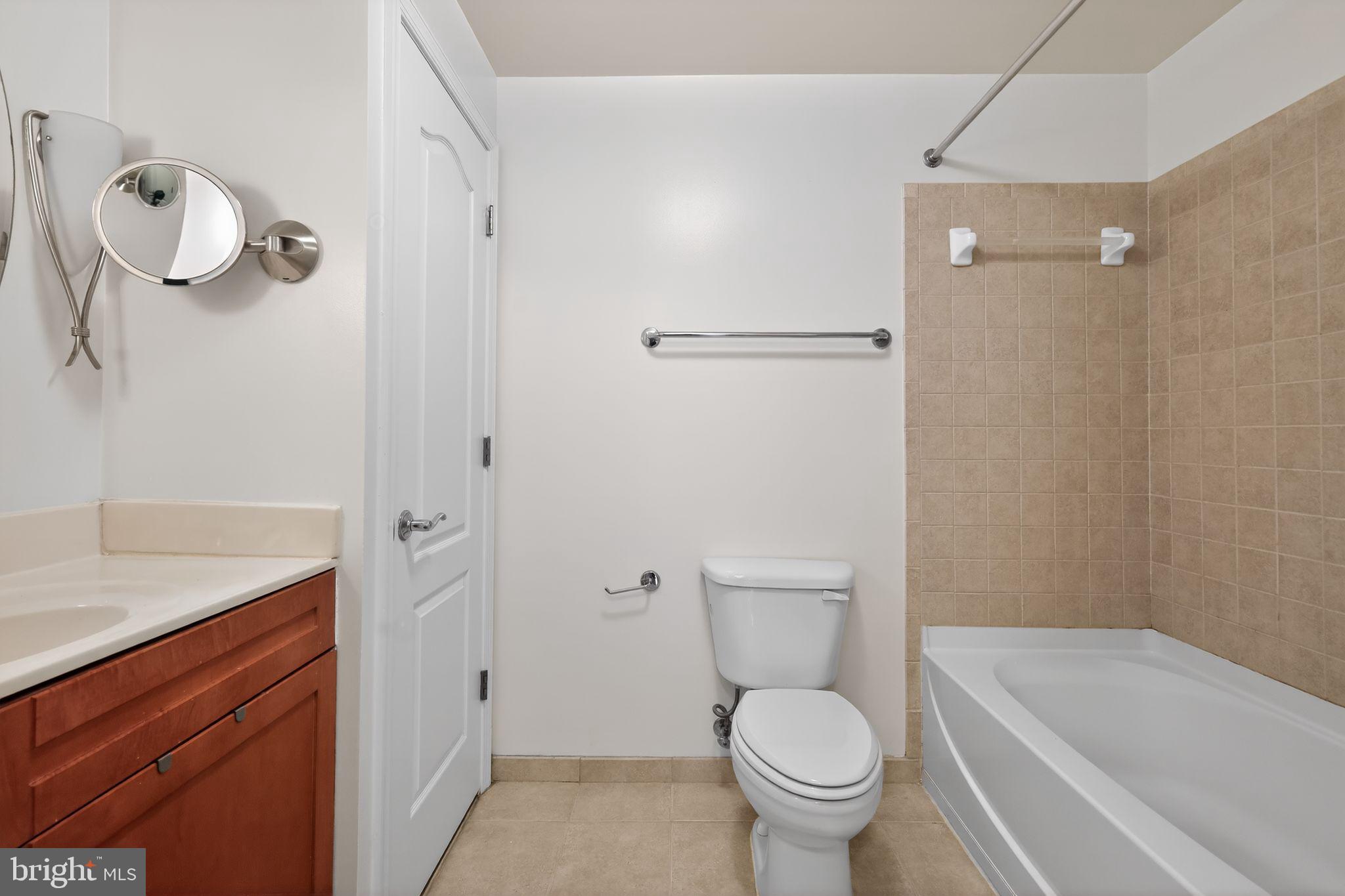 1111 11th Street Northwest, Unit 308 Washington, DC 20001 - Photo 19 of 47 a white toilet sitting next to a bathroom sink and tub