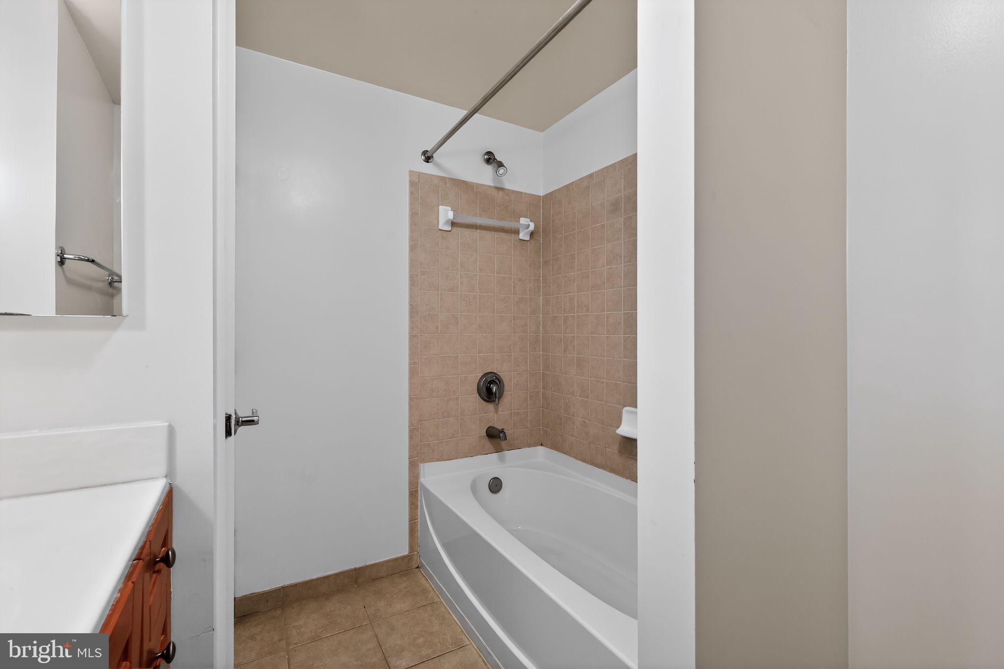1111 11th Street Northwest, Unit 308 Washington, DC 20001 - Photo 20 of 47 a bathroom with a tub a sink and a shower