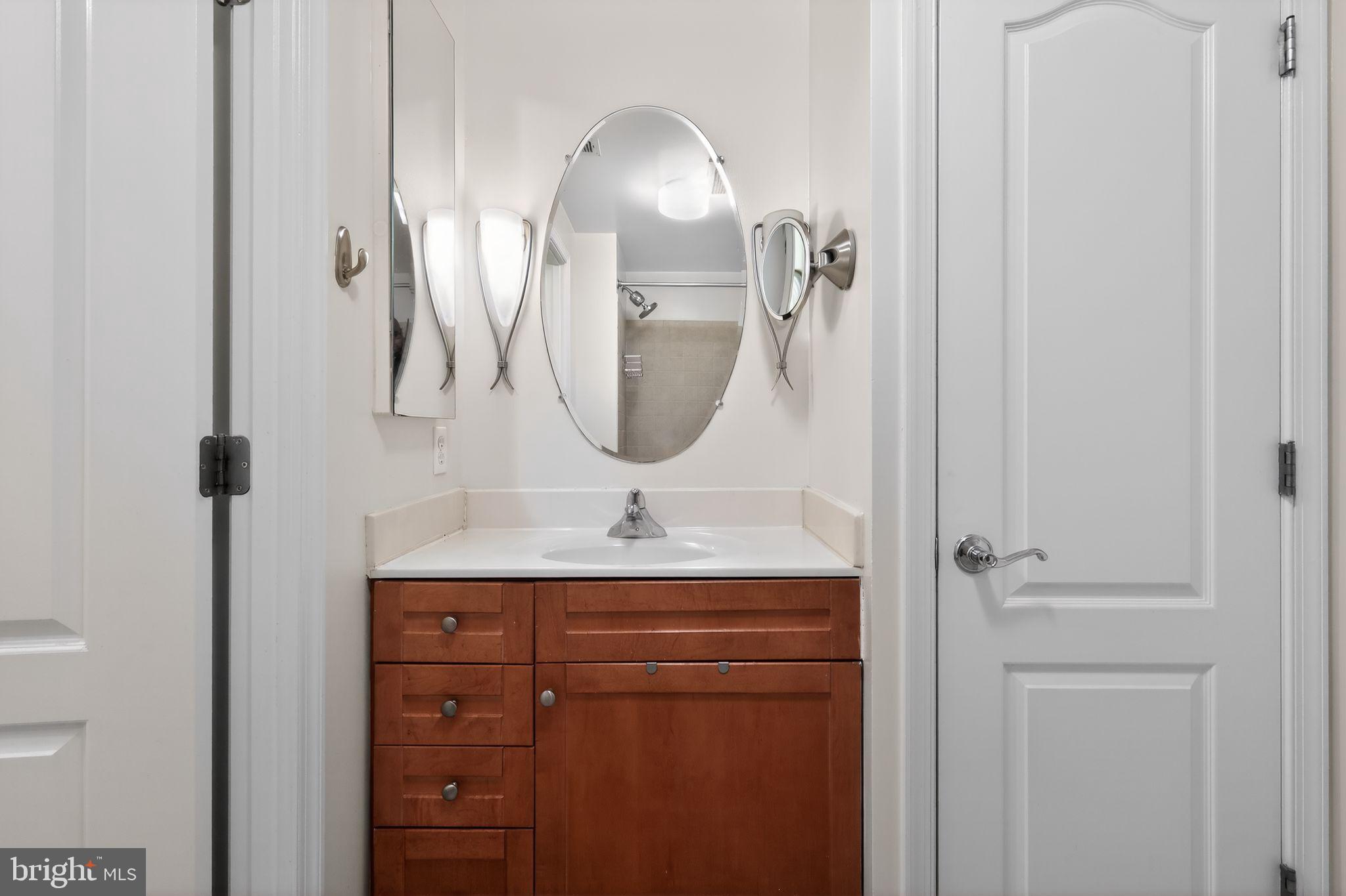 1111 11th Street Northwest, Unit 308 Washington, DC 20001 - Photo 22 of 47 a bathroom with a sink and a mirror