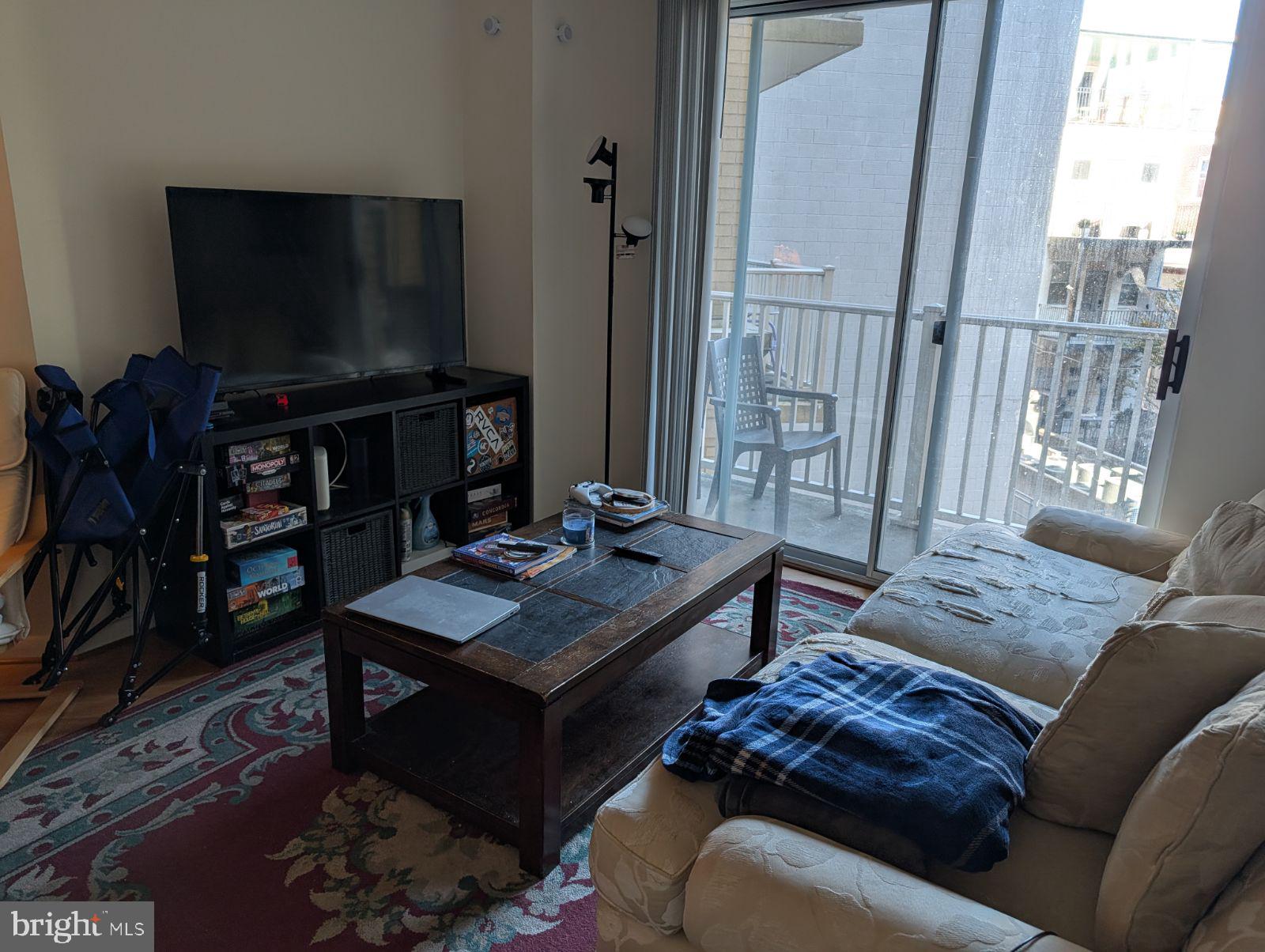 1111 11th Street Northwest, Unit 308 Washington, DC 20001 - Photo 27 of 47 a living room with furniture and a flat screen tv