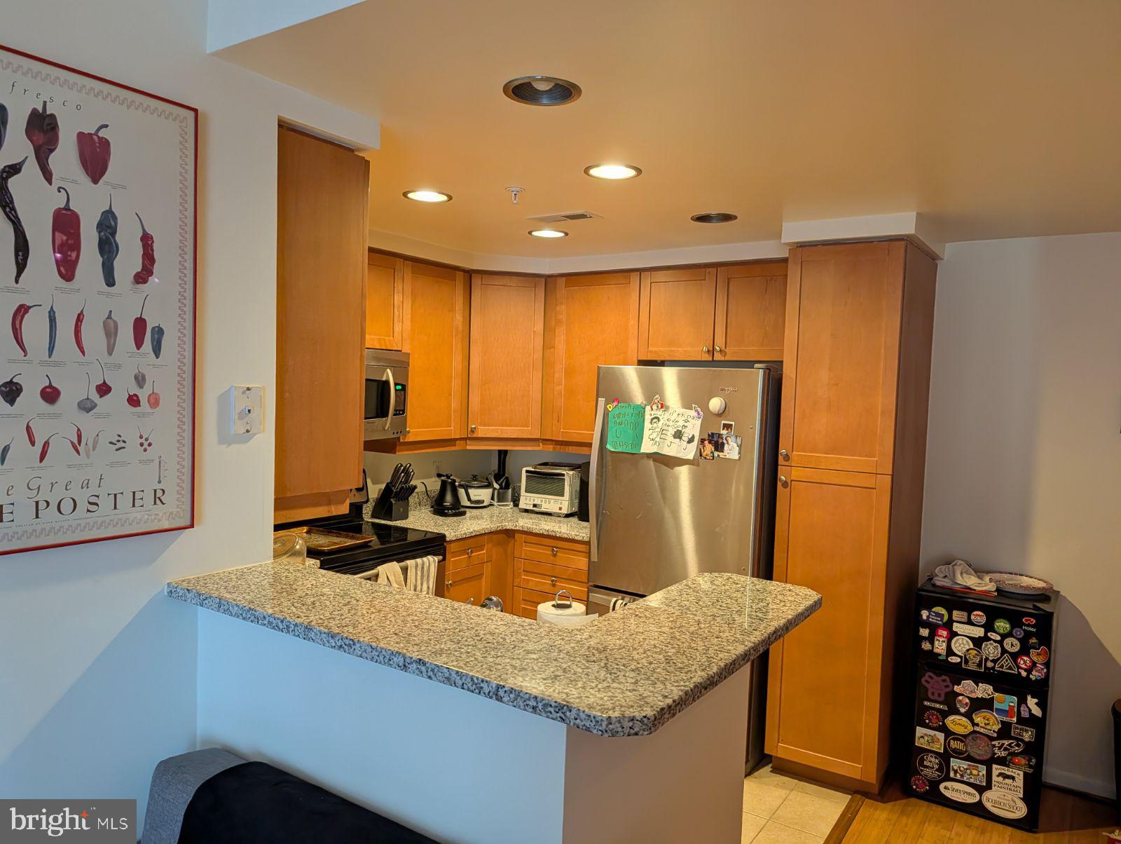 1111 11th Street Northwest, Unit 308 Washington, DC 20001 - Photo 29 of 47 a kitchen with stainless steel appliances granite countertop a sink a refrigerator and a stove