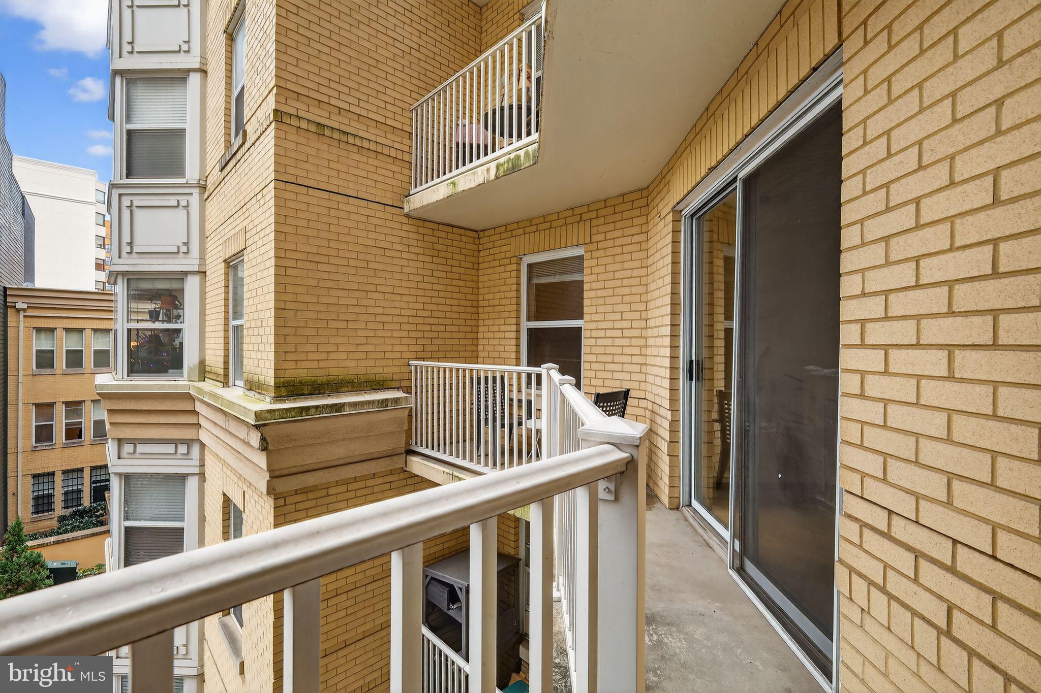 1111 11th Street Northwest, Unit 308 Washington, DC 20001 - Photo 33 of 47 a view of balcony with wooden floor and fence and a window