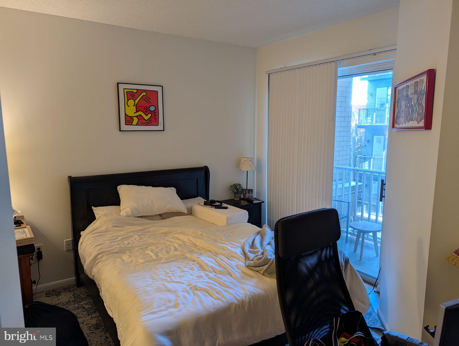 1111 11th Street Northwest, Unit 308 Washington, DC 20001 - Photo 37 of 47 a bedroom with a bed and a table in it