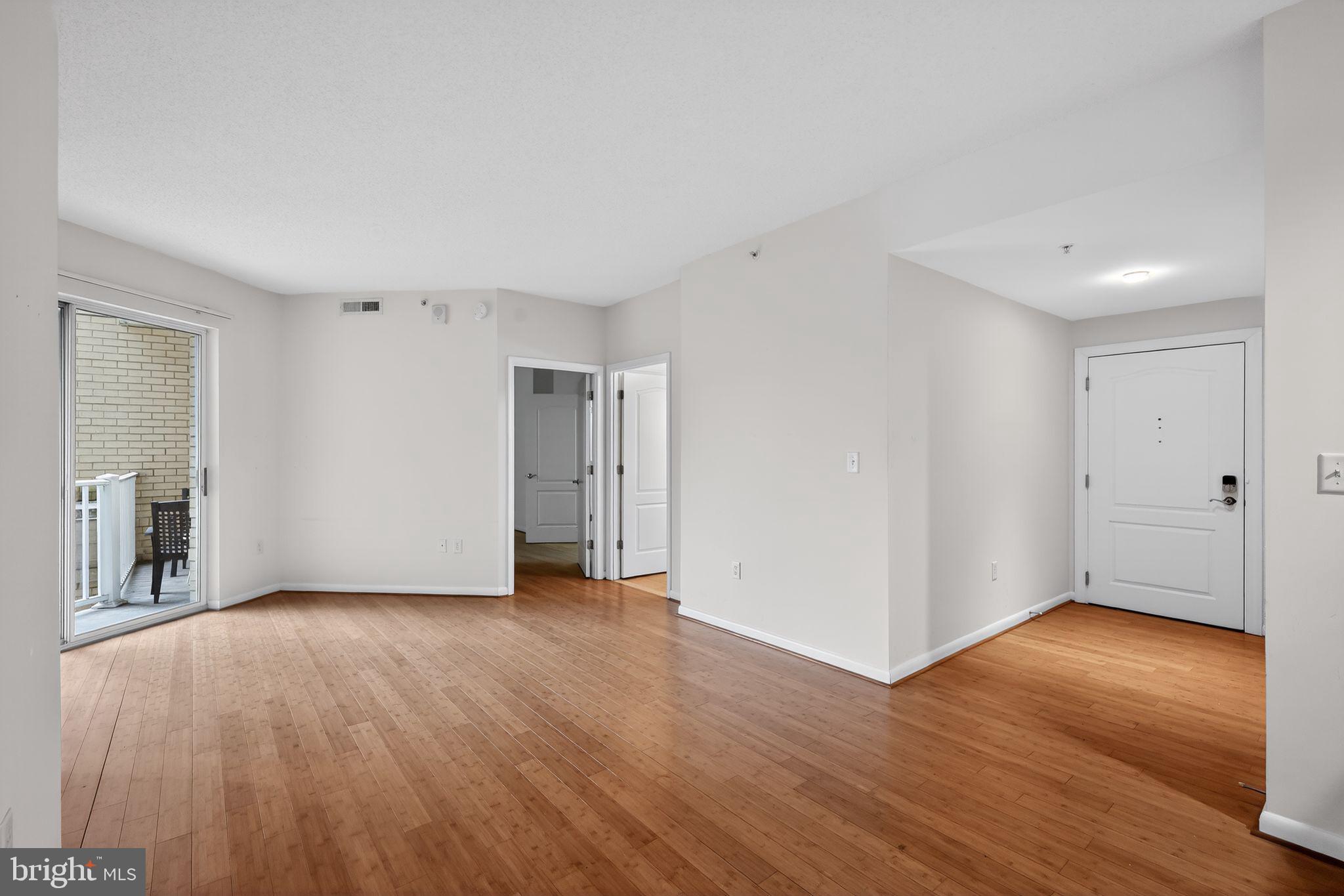 1111 11th Street Northwest, Unit 308 Washington, DC 20001 - Photo 8 of 47 a view of an empty room with wooden floor