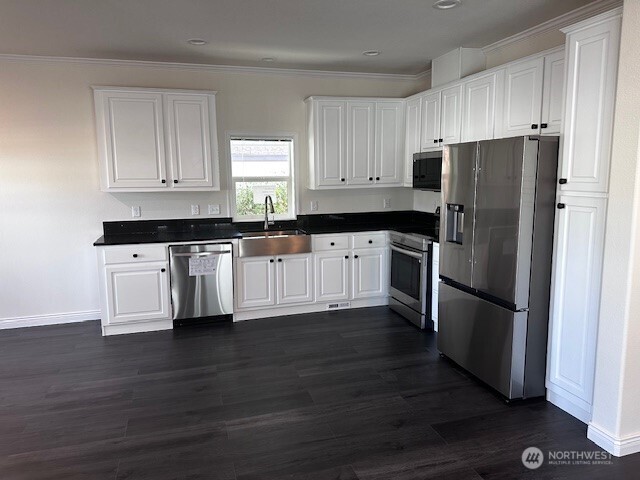2101 South 324th Street, Unit 174 Federal Way, WA 98003 - Photo 2 of 9 a kitchen with granite countertop a refrigerator and a stove top oven