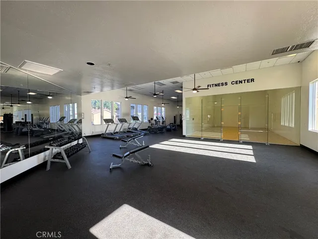 a view of a patio with a table and chairs under an umbrella