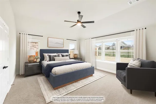 a spacious bedroom with a large bed and a couch