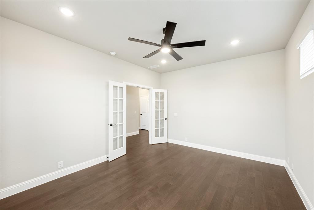 4021 Eagles Bluff Road Midlothian, TX 76065 - Photo 23 of 40 an empty room with wooden floor and windows