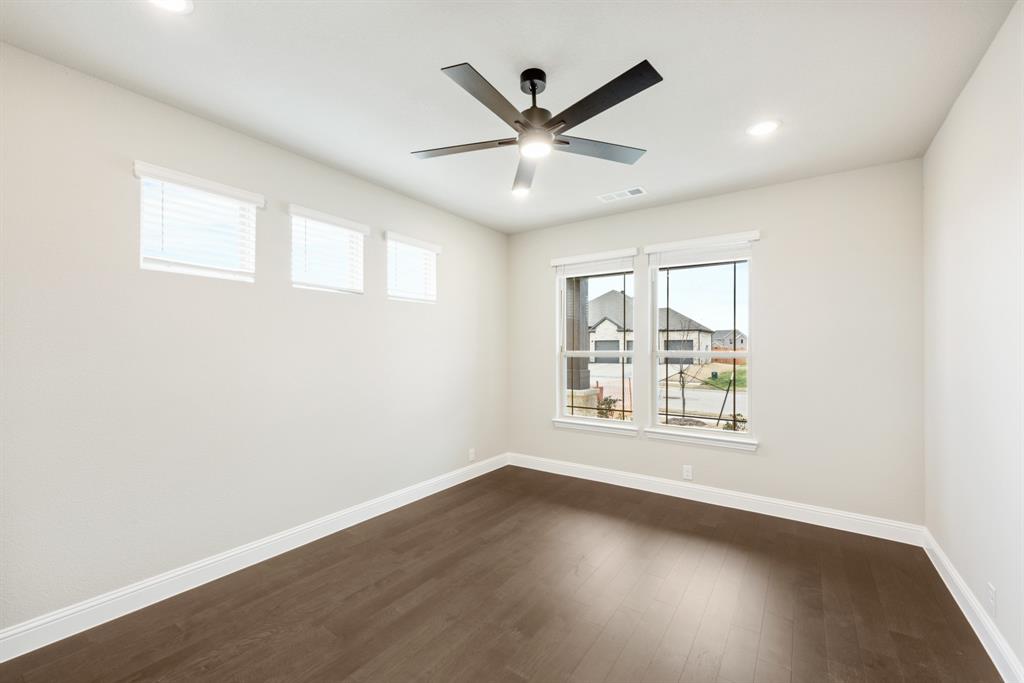 4021 Eagles Bluff Road Midlothian, TX 76065 - Photo 24 of 40 an empty room with wooden floor and windows