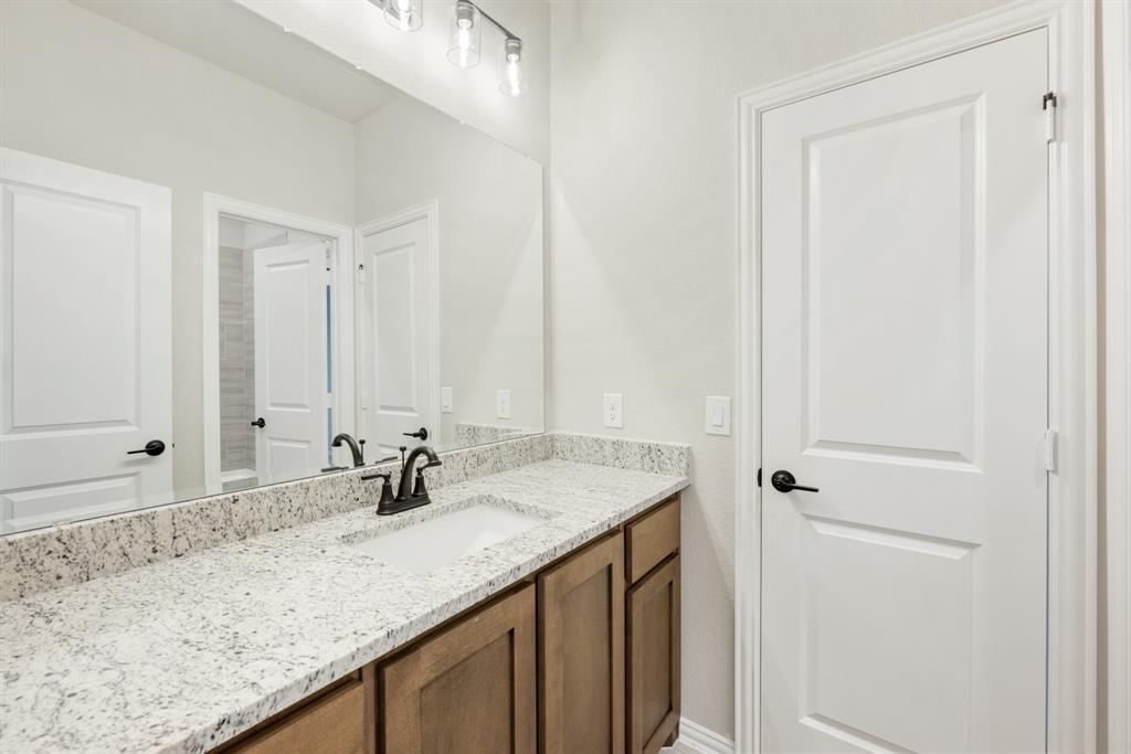4021 Eagles Bluff Road Midlothian, TX 76065 - Photo 33 of 40 a bathroom with a sink and a mirror