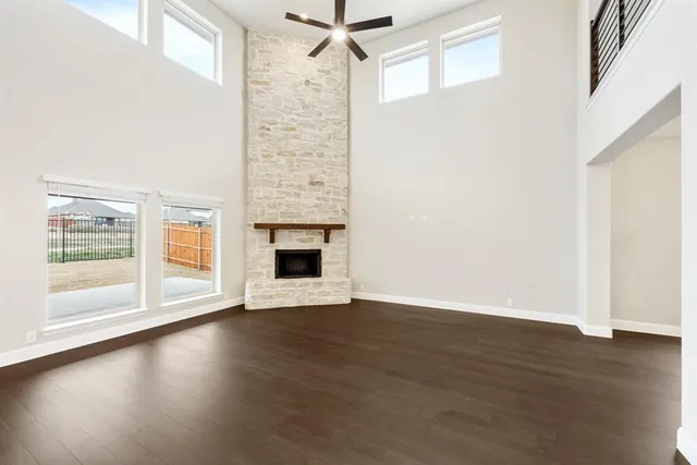 a view of empty room with wooden floor and fireplace