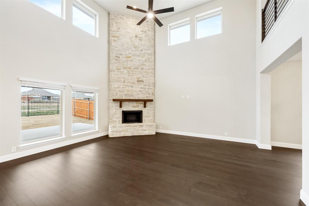 4021 Eagles Bluff Road Midlothian, TX 76065 - Photo 9 of 40 a view of empty room with wooden floor and fireplace