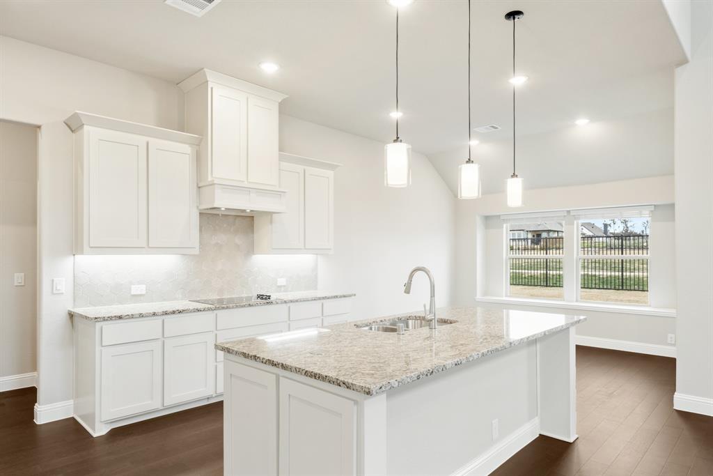 4021 Eagles Bluff Road Midlothian, TX 76065 - Photo 10 of 40 a kitchen with a sink a center island appliances and a large window
